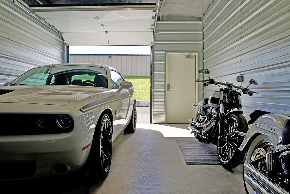 Photo of inside storage unit showing Car and motorcycle inside